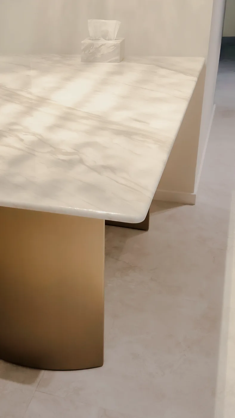 Daylight falling across the polished surface of a Calacatta Beige table